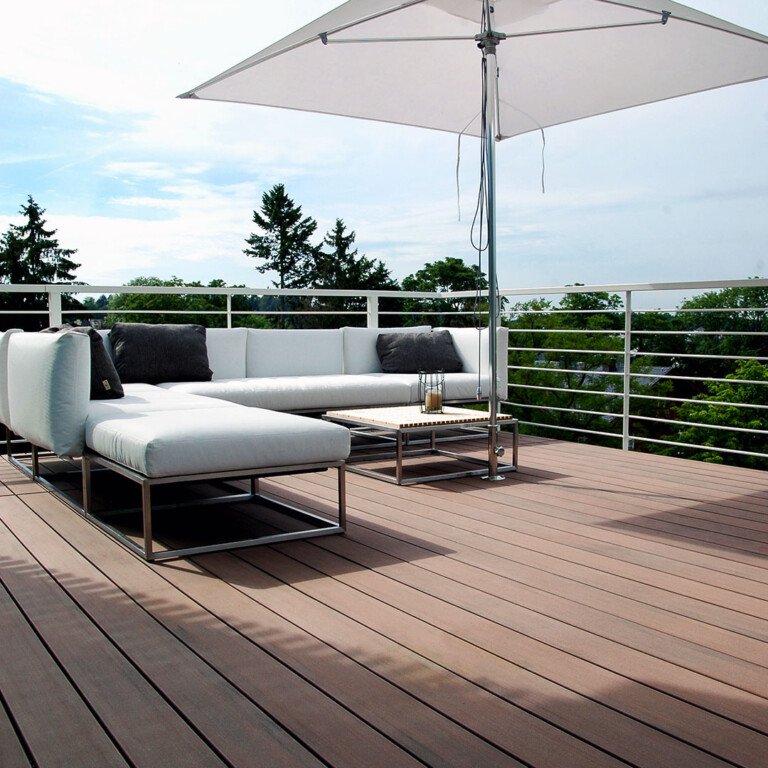 Balkon mit moderner langlebiger Holzterrasse in braun und modernen Balkonmöbeln